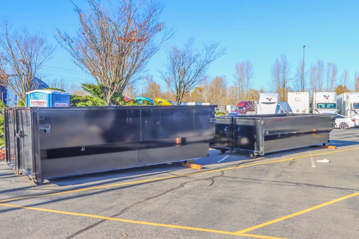 Professional dumpster rental service with roll-off container on residential driveway in Van Alstyne